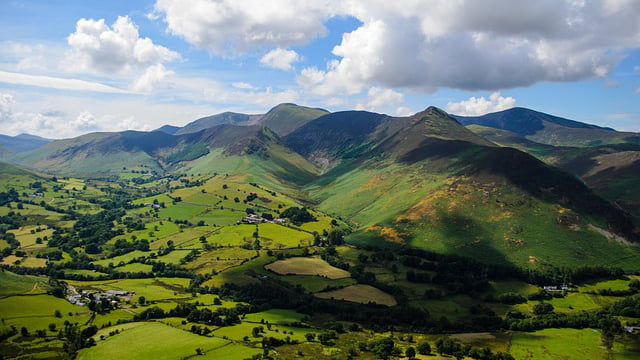 Landscape photograph of the rolling green Lake District mountains in the sunshine